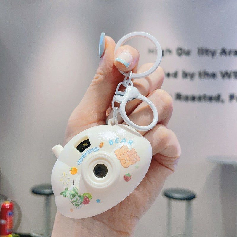 "Cartoon Mini Cloud Camera Projection Lamp Keychain – Fun & Whimsical Light-Up Accessory"